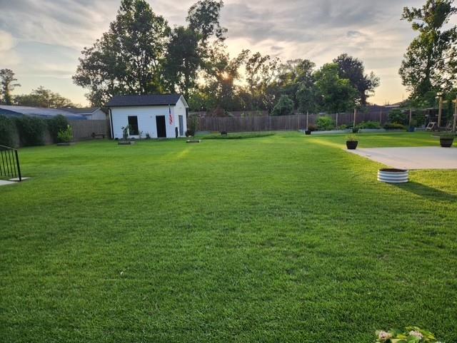 view of yard with an outdoor structure and fence