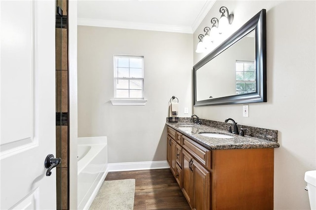 full bathroom featuring a sink, ornamental molding, a tub to relax in, and wood finished floors