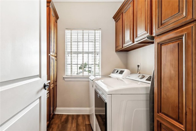 washroom with cabinet space, separate washer and dryer, baseboards, and dark wood-style floors