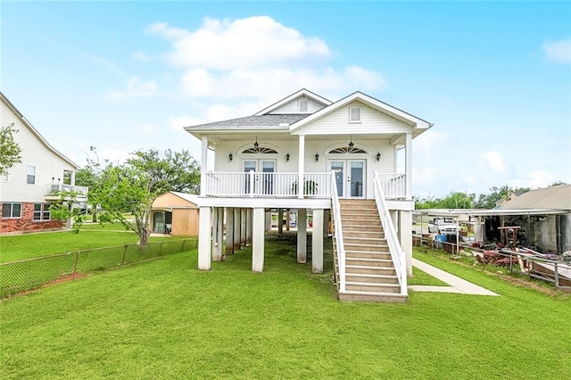 back of property featuring ceiling fan, french doors, fence, a yard, and stairs