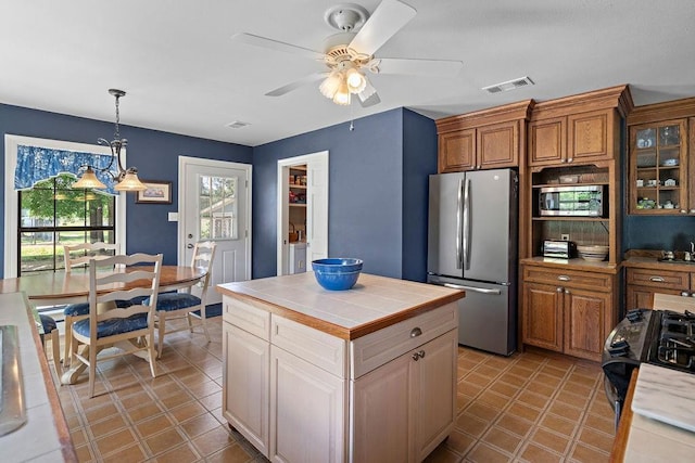 155 Greencrest Dr, Slidell, LA 70458 - kitchen with tile counters, stainless steel appliances, a ceiling fan, light tile patterned floors, and visible vents