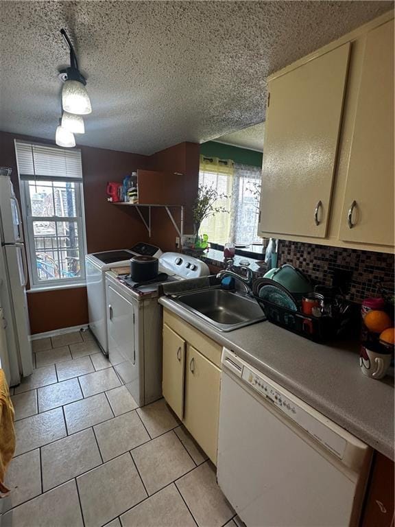 6320 Riverside Dr Unit 350, Metairie, LA 70003 - kitchen featuring freestanding refrigerator, a healthy amount of sunlight, a sink, and dishwasher