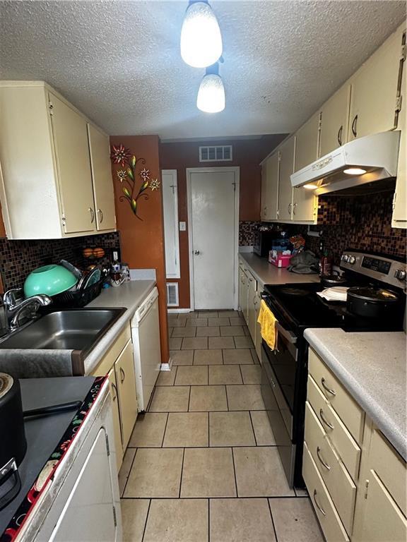 6320 Riverside Dr Unit 350, Metairie, LA 70003 - kitchen featuring electric range, visible vents, white dishwasher, range, and under cabinet range hood