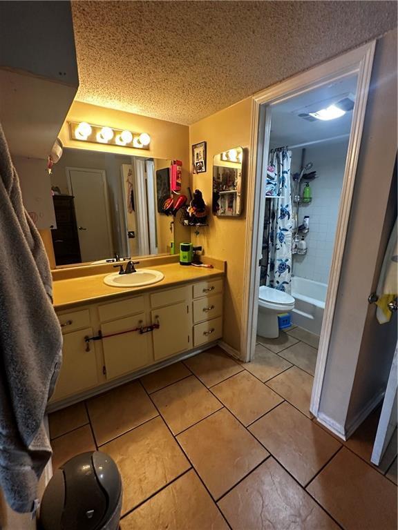 6320 Riverside Dr Unit 350, Metairie, LA 70003 - full bathroom with tile patterned floors, vanity, toilet, and a textured ceiling