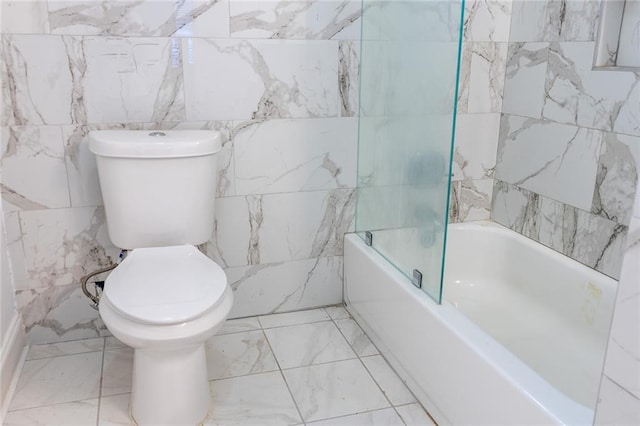 full bath featuring marble finish floor, bathing tub / shower combination, toilet, and tile walls