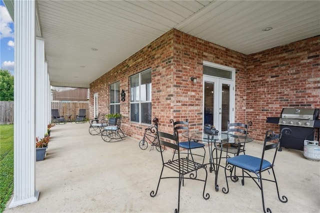 view of patio / terrace with french doors, fence, and grilling area