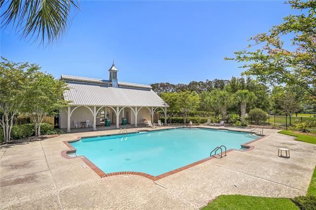 community pool with a patio area and fence