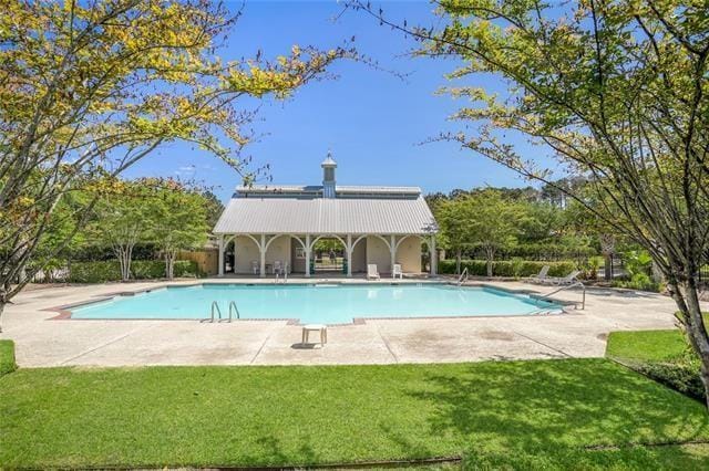 pool featuring a yard, fence, and a patio area
