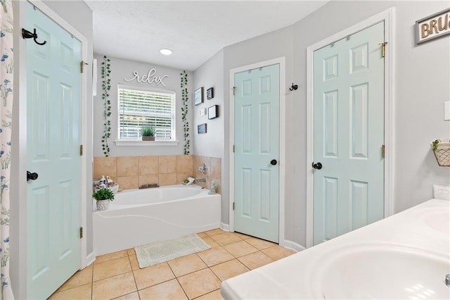 bathroom with vanity, tile patterned floors, and a garden tub