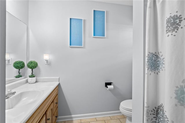 full bathroom featuring vanity, tile patterned flooring, baseboards, and toilet