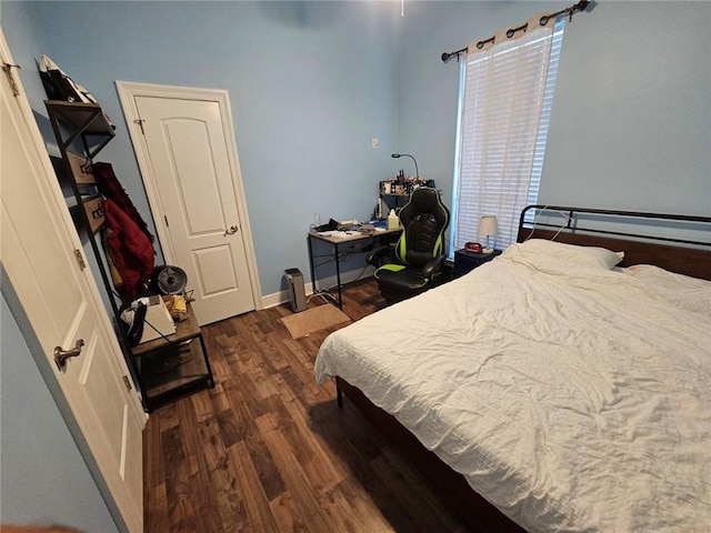 bedroom with baseboards and wood finished floors
