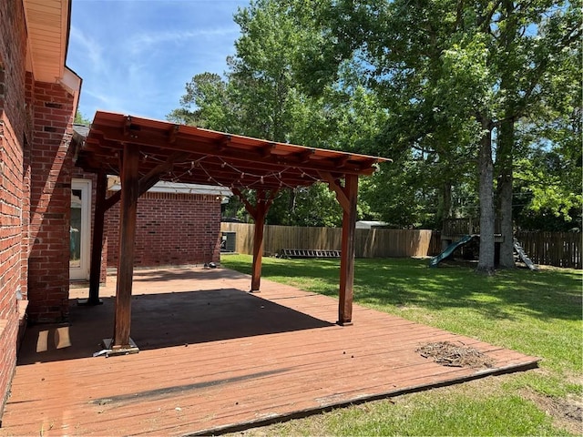 deck with a yard and a fenced backyard