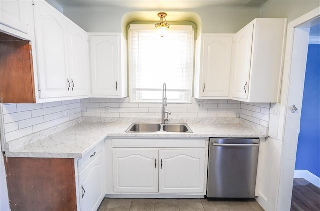3220 48th St, Metairie, LA 70001 - kitchen featuring decorative backsplash, dishwasher, a sink, light countertops, and white cabinets