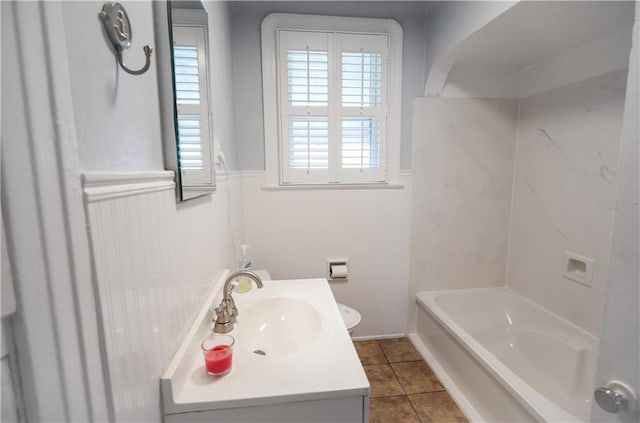3220 48th St, Metairie, LA 70001 - bathroom featuring vanity, toilet, tile patterned flooring, and a wainscoted wall