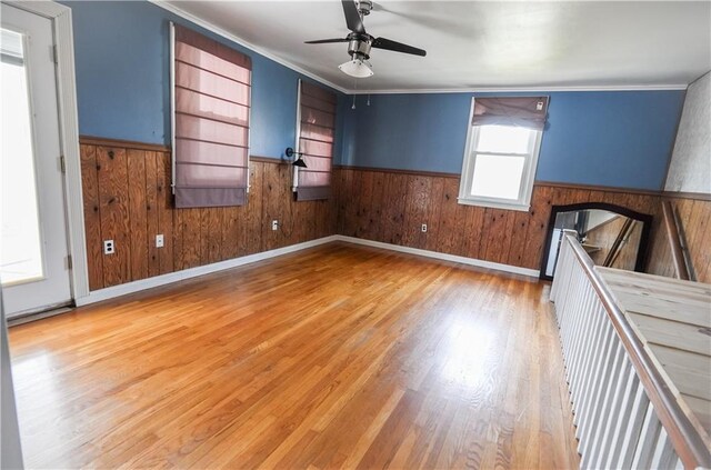 3220 48th St, Metairie, LA 70001 - unfurnished room with wooden walls, a ceiling fan, wood finished floors, and a wainscoted wall