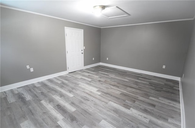 3220 48th St, Metairie, LA 70001 - spare room featuring baseboards, ornamental molding, attic access, and wood finished floors