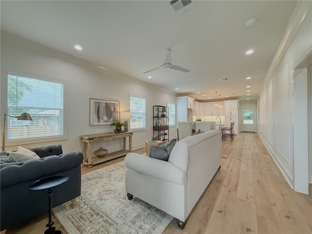 2412 Mississippi Ave, Metairie, LA 70003 - living area with crown molding, light wood finished floors, and recessed lighting