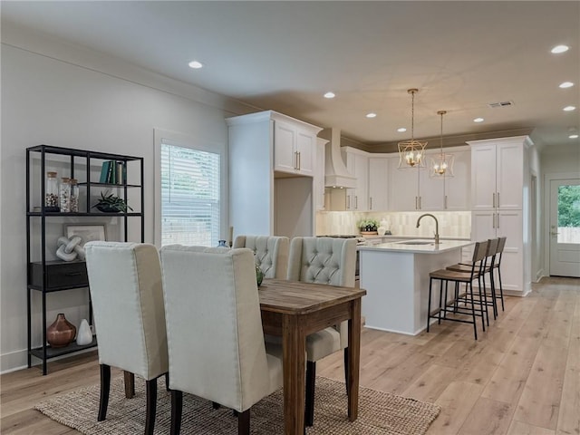 2412 Mississippi Ave, Metairie, LA 70003 - dining room with light wood finished floors and recessed lighting