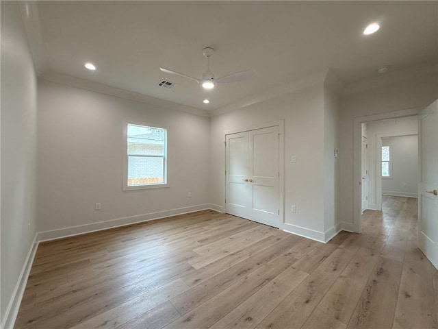 2412 Mississippi Ave, Metairie, LA 70003 - unfurnished bedroom with crown molding, light wood-style floors, recessed lighting, a ceiling fan, and a closet