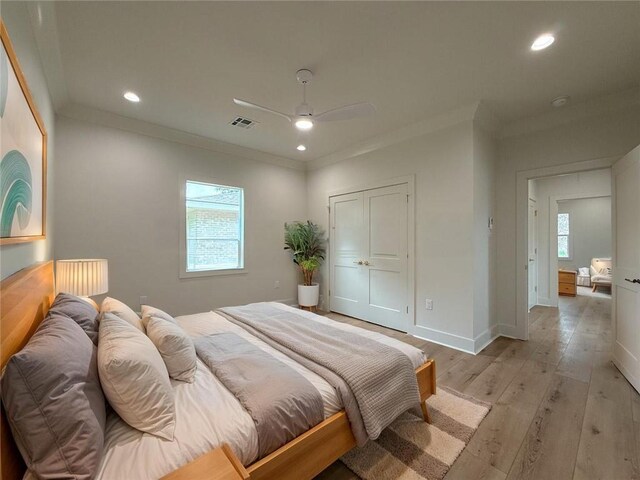 2412 Mississippi Ave, Metairie, LA 70003 - bedroom featuring crown molding, recessed lighting, light wood-style floors, a ceiling fan, and a closet