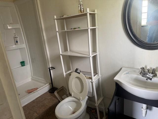 full bathroom with a stall shower and toilet