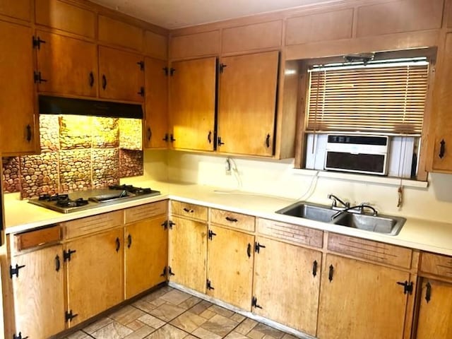3076 Elgin St, Baton Rouge, LA 70805 - kitchen featuring under cabinet range hood, a sink, light countertops, stone finish floors, and stainless steel gas cooktop
