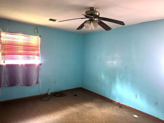 spare room featuring ceiling fan, baseboards, and carpet