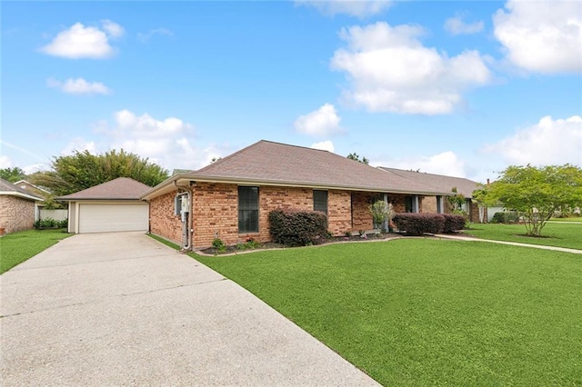 ranch-style house featuring a detached garage, brick siding, and a front yard