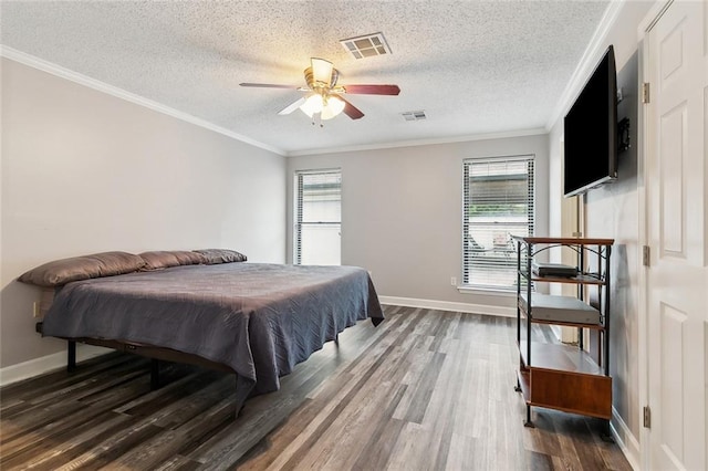 bedroom with multiple windows, wood finished floors, and visible vents