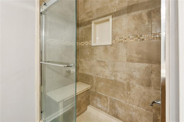 bathroom with a tile shower