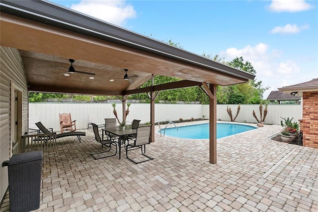 view of swimming pool with a ceiling fan, outdoor dining area, a fenced in pool, a fenced backyard, and a patio