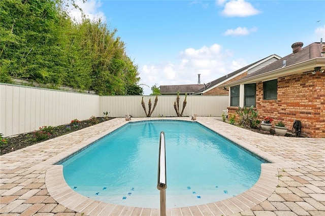 view of swimming pool with a fenced in pool, a fenced backyard, and a patio area