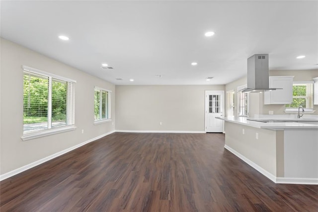 6815 Calumet St, Baton Rouge, LA 70805 - unfurnished living room with visible vents, dark wood-style flooring, baseboards, recessed lighting, and a sink