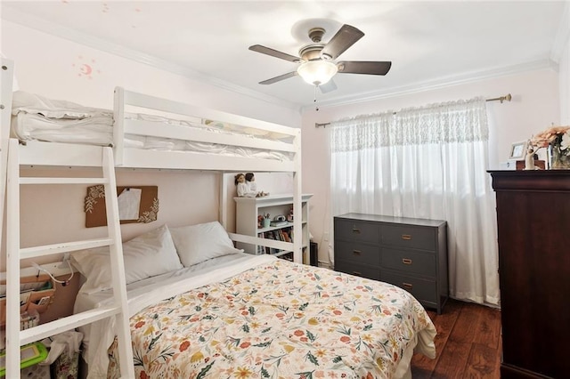 bedroom with ornamental molding, dark wood finished floors, and a ceiling fan