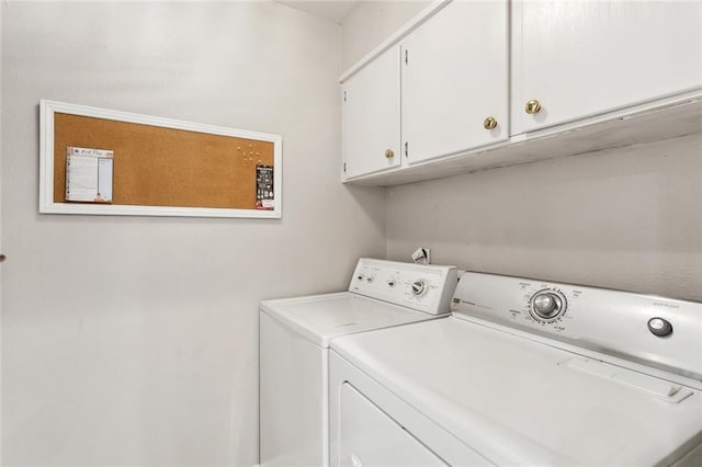 laundry room with washer and clothes dryer and cabinet space