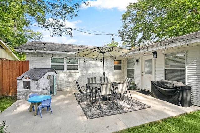 view of patio with fence and outdoor dining space