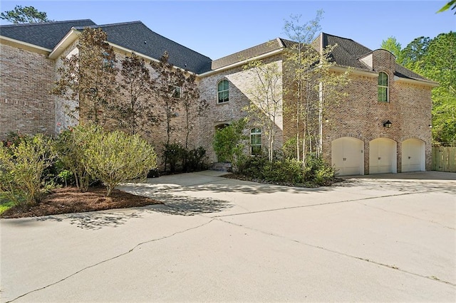 view of property featuring a garage and driveway