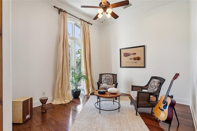 sitting room with crown molding, baseboards, a ceiling fan, and visible vents