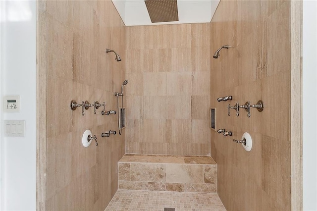 full bath with a tile shower