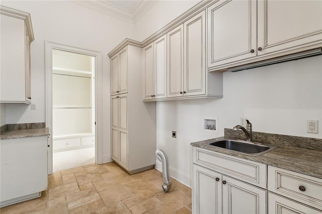 clothes washing area featuring crown molding, hookup for an electric dryer, a sink, cabinet space, and washer hookup