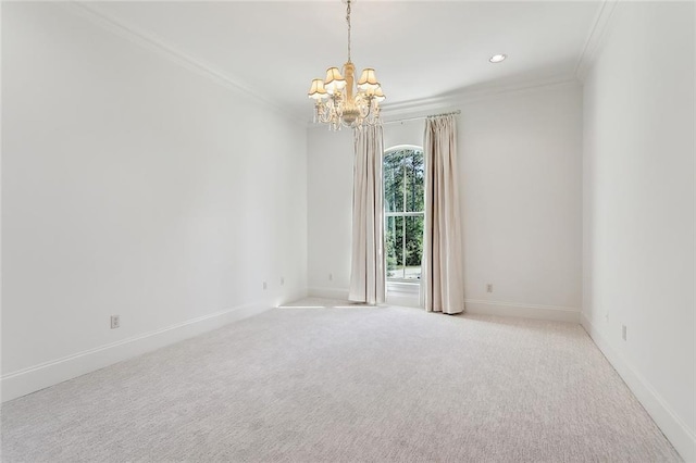 carpeted empty room featuring crown molding, baseboards, and a chandelier
