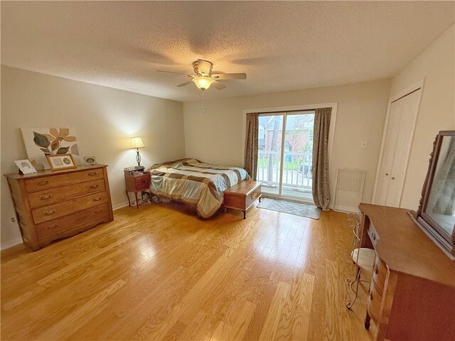 308 Ormond Meadows Dr Unit B, Destrehan, LA 70047 - bedroom with ceiling fan, a textured ceiling, access to exterior, baseboards, and light wood-style floors