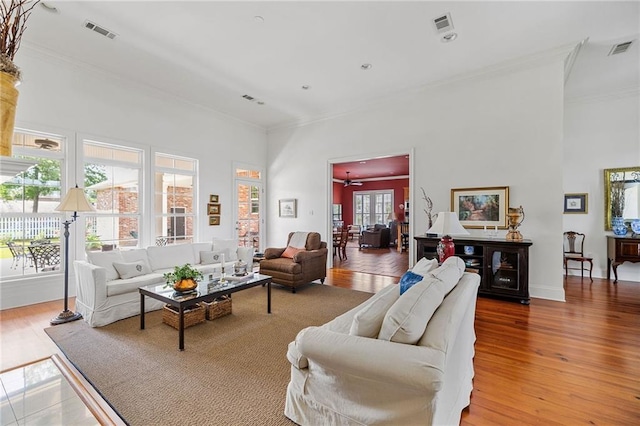 609 W Dakota St, Hammond, LA 70401 - living area featuring visible vents, crown molding, and a high ceiling