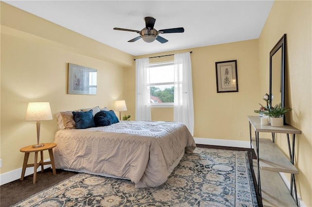 bedroom featuring baseboards and ceiling fan