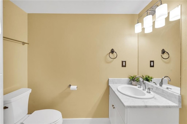 half bathroom featuring vanity and toilet