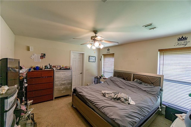 11257 Abbey Ln, Denham Springs, LA 70726 - bedroom with ceiling fan, visible vents, and light carpet