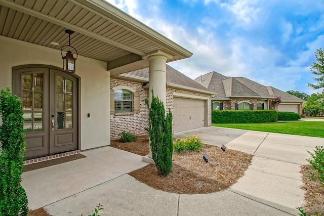 property entrance featuring driveway, french doors, roof with shingles, a garage, and brick siding