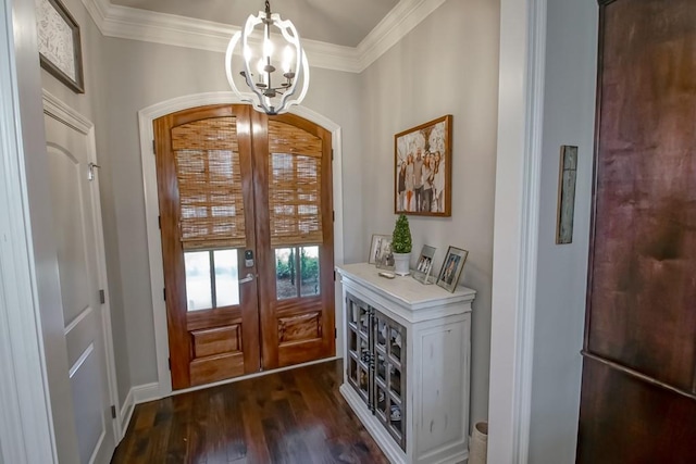 doorway to outside with dark wood-type flooring, ornamental molding, baseboards, and a chandelier
