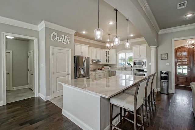kitchen featuring visible vents, crown molding, appliances with stainless steel finishes, and white cabinets
