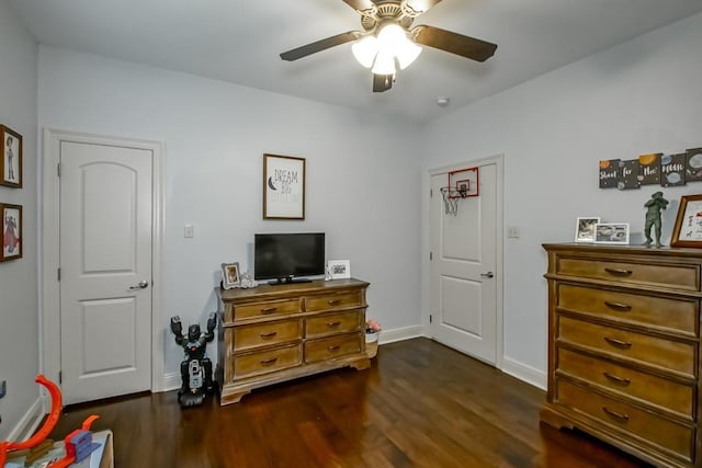 bedroom with baseboards, ceiling fan, and dark wood-style floors